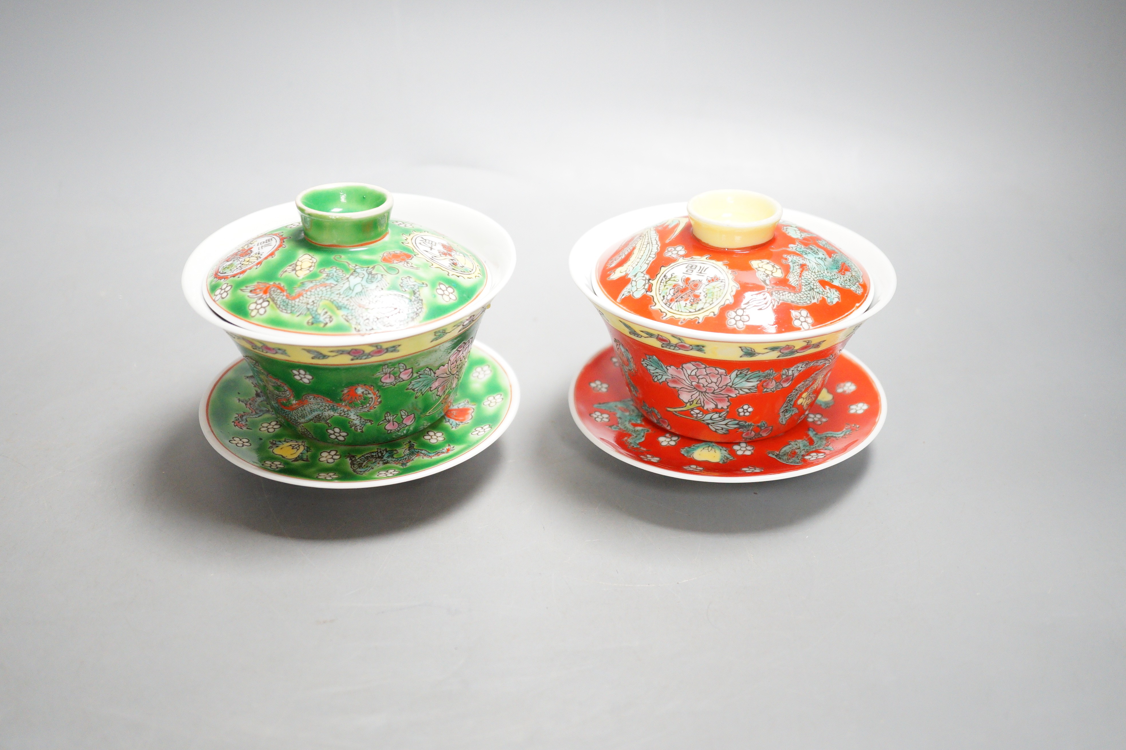 Two Chinese enamelled porcelain bowls, cover and stands and one plate, 19th/20th century, 20.5cm diameter
